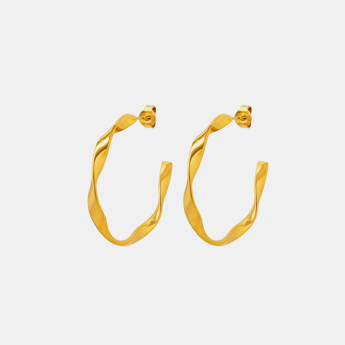 Gold-tone 18K gold-plated titanium steel C-hoop earrings feature a sculpted, gently twisted silhouette with smooth polished construction and butterfly backs.