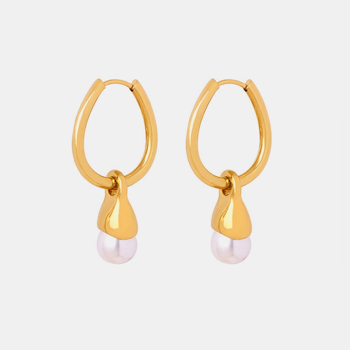 Gold-plated titanium steel huggie earrings feature polished oval hoops with dangling sculpted teardrop charms and soft synthetic pearl accents.