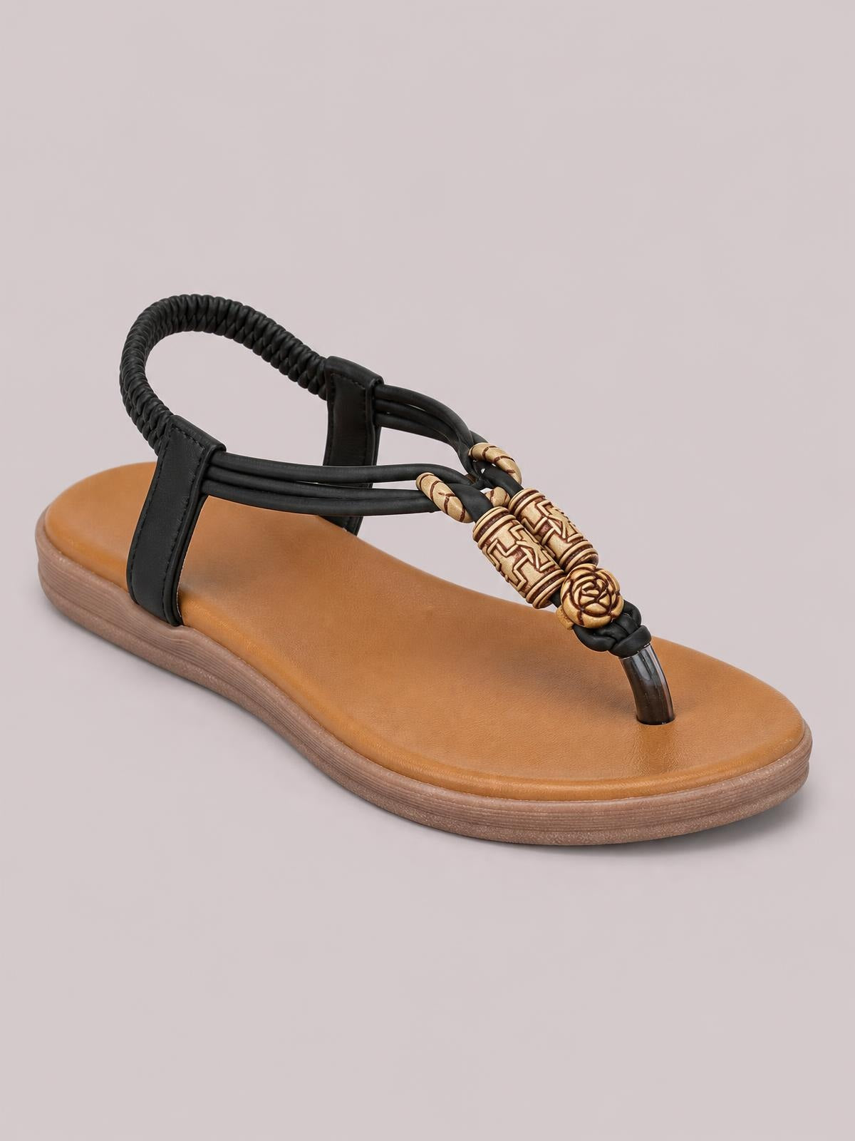 Black PU leather toe post flat sandal with braided straps, decorative tan beads, cushioned tan footbed, and a low rubber sole.