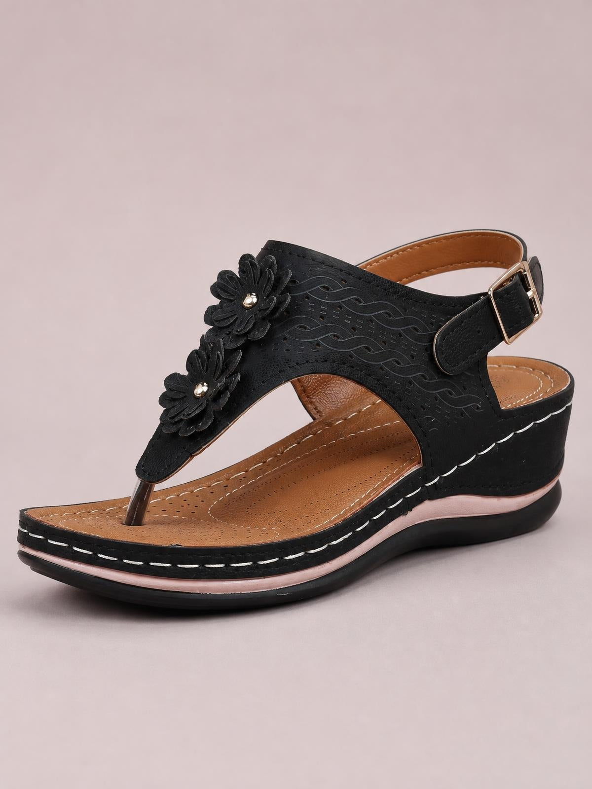 Black toe post flower detail wedge sandal with layered floral appliqués, ankle buckle strap, perforated upper, and stitched mid-height platform sole.