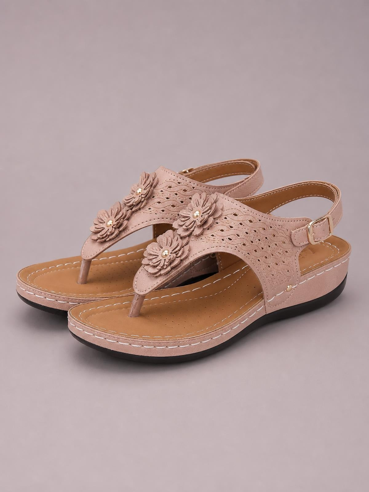 Blush PU leather toe post wedge sandals feature layered flower details, cutout straps, an adjustable ankle buckle, and a stitched mid-height platform sole.