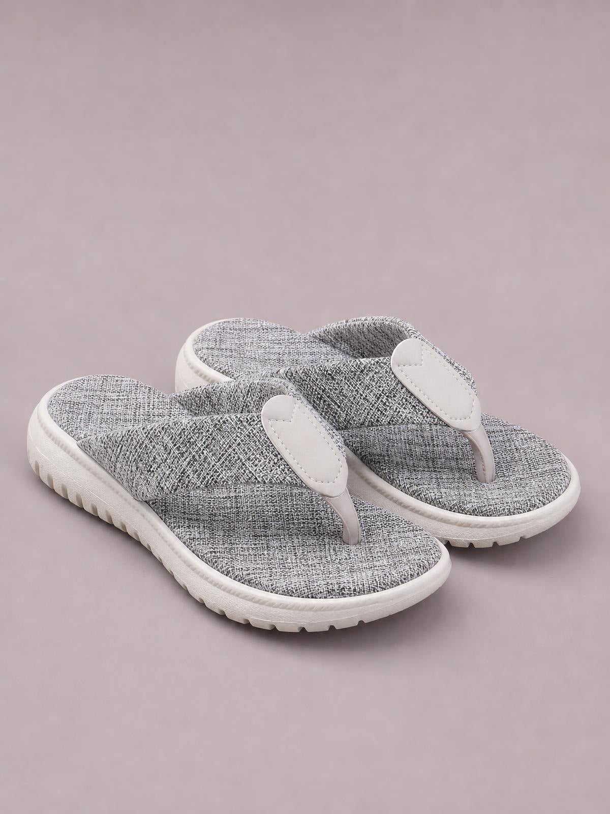 Gray heathered toe post sandals feature textured thong straps, cushioned footbeds, and flat white rubber soles with a subtly ridged tread.