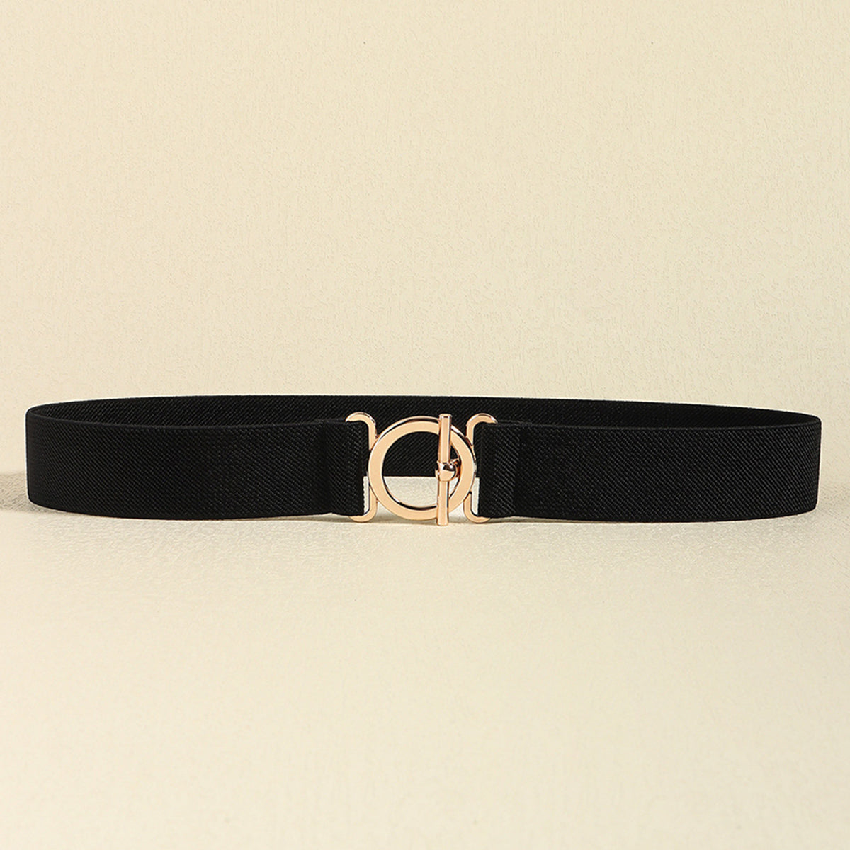Black 1.2-inch elastic belt with a streamlined silhouette and centered polished gold-tone 2-inch toggle-style clasp.