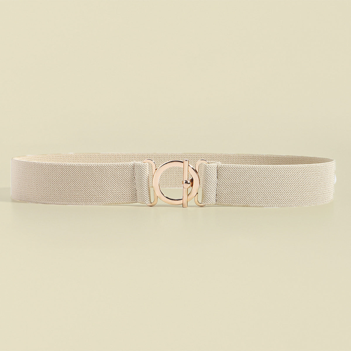 Cream elastic belt with a streamlined 1.2-inch width, stitched construction, and centered polished toggle-style clasp for a refined waist-defining finish.
