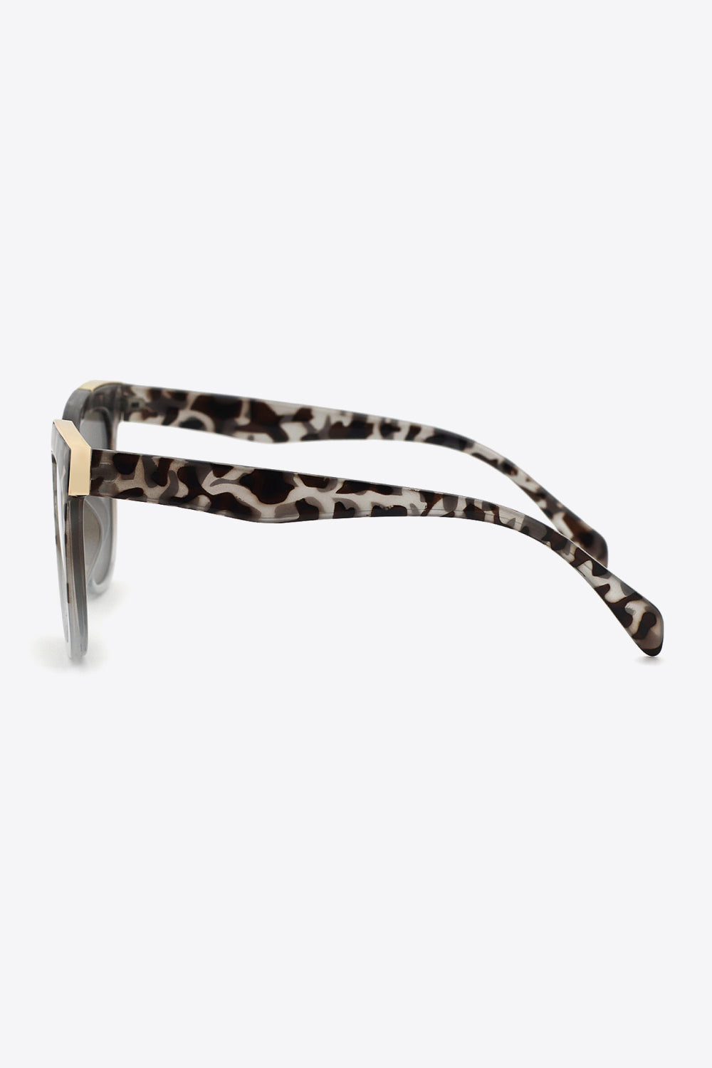 Light gray tortoiseshell polycarbonate sunglasses shown in side profile with full-rim square frames, subtly tinted gray lenses, and broad curved temples.