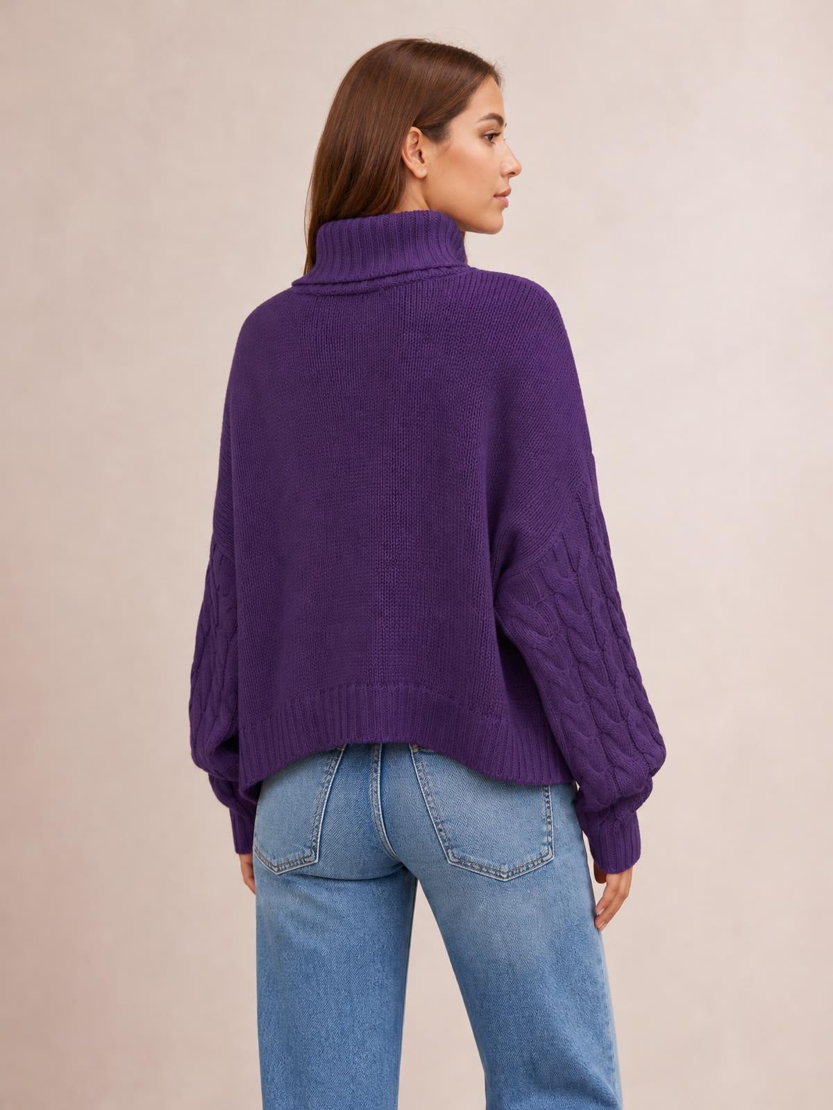 A model looks over her shoulder wearing a solid purple cable-knit turtleneck sweater with long sleeves, ribbed cuffs and hem, and a relaxed regular silhouette.