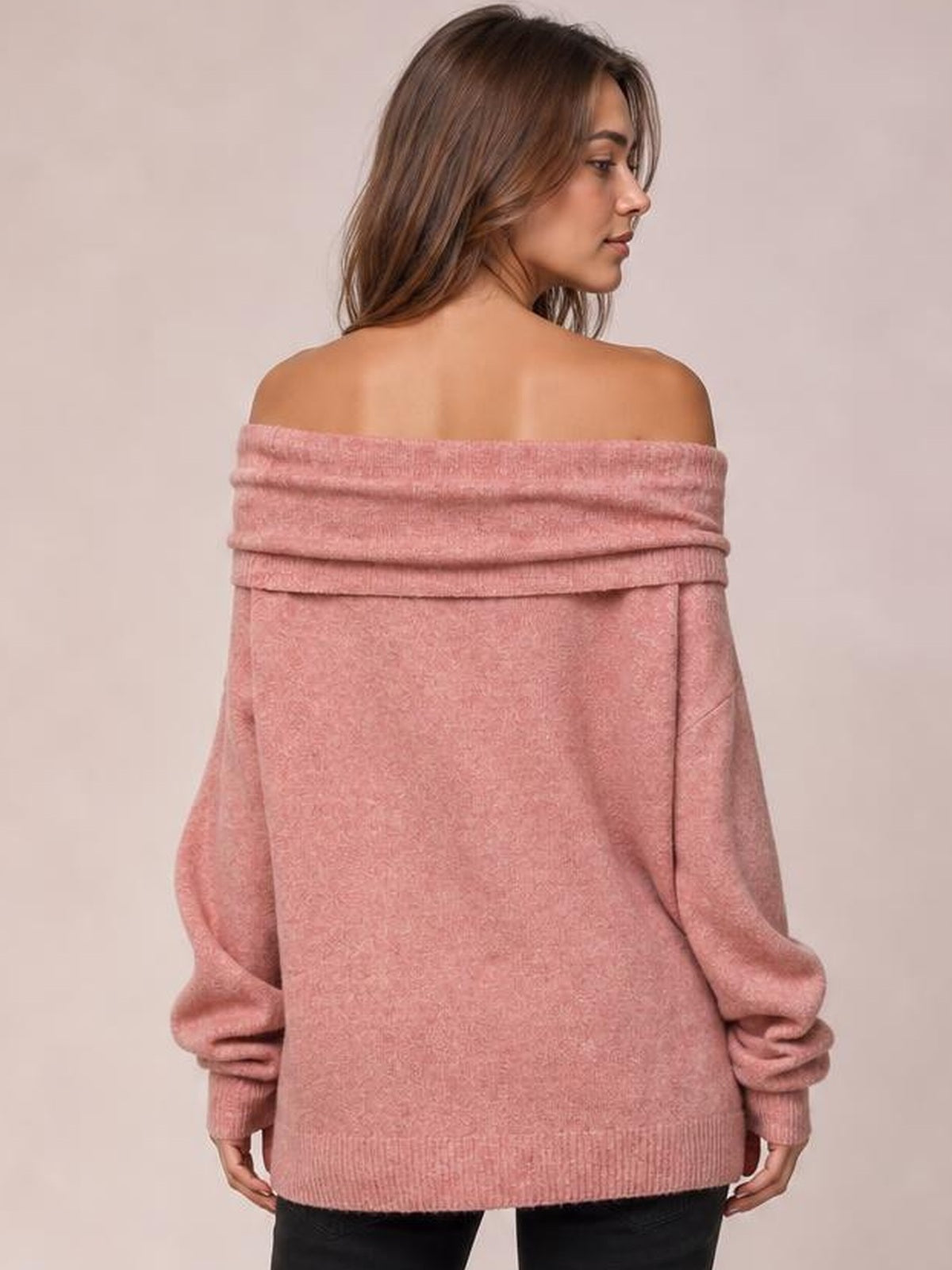 Model shown from behind wearing a dusty pink long sleeve sweater with a wide folded neckline, relaxed oversized silhouette, ribbed cuffs, and ribbed hem.