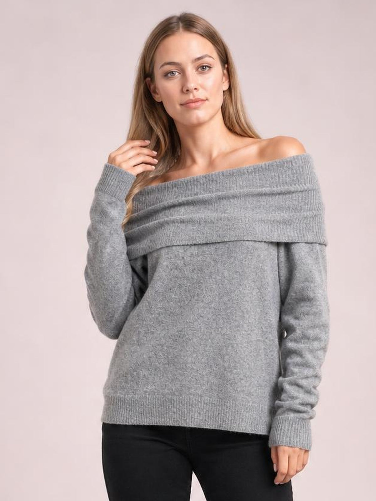 Model poses in a gray long sleeve sweater with a wide foldover neckline, relaxed silhouette, and ribbed cuffs and hem.