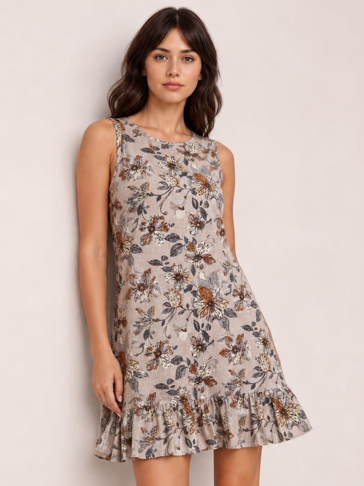 Model wears a taupe floral tweed sleeveless mini dress with a round neckline, relaxed straight silhouette, and flounced ruffle hem.