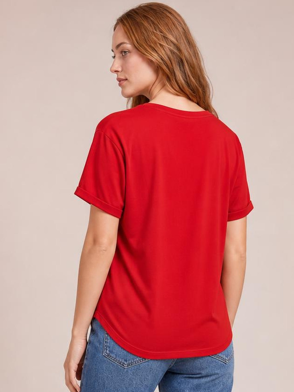 A model looks over her shoulder wearing a red USA round-neck short-sleeve T-shirt with a classic fit, rolled cuffs, and a gently curved hem.