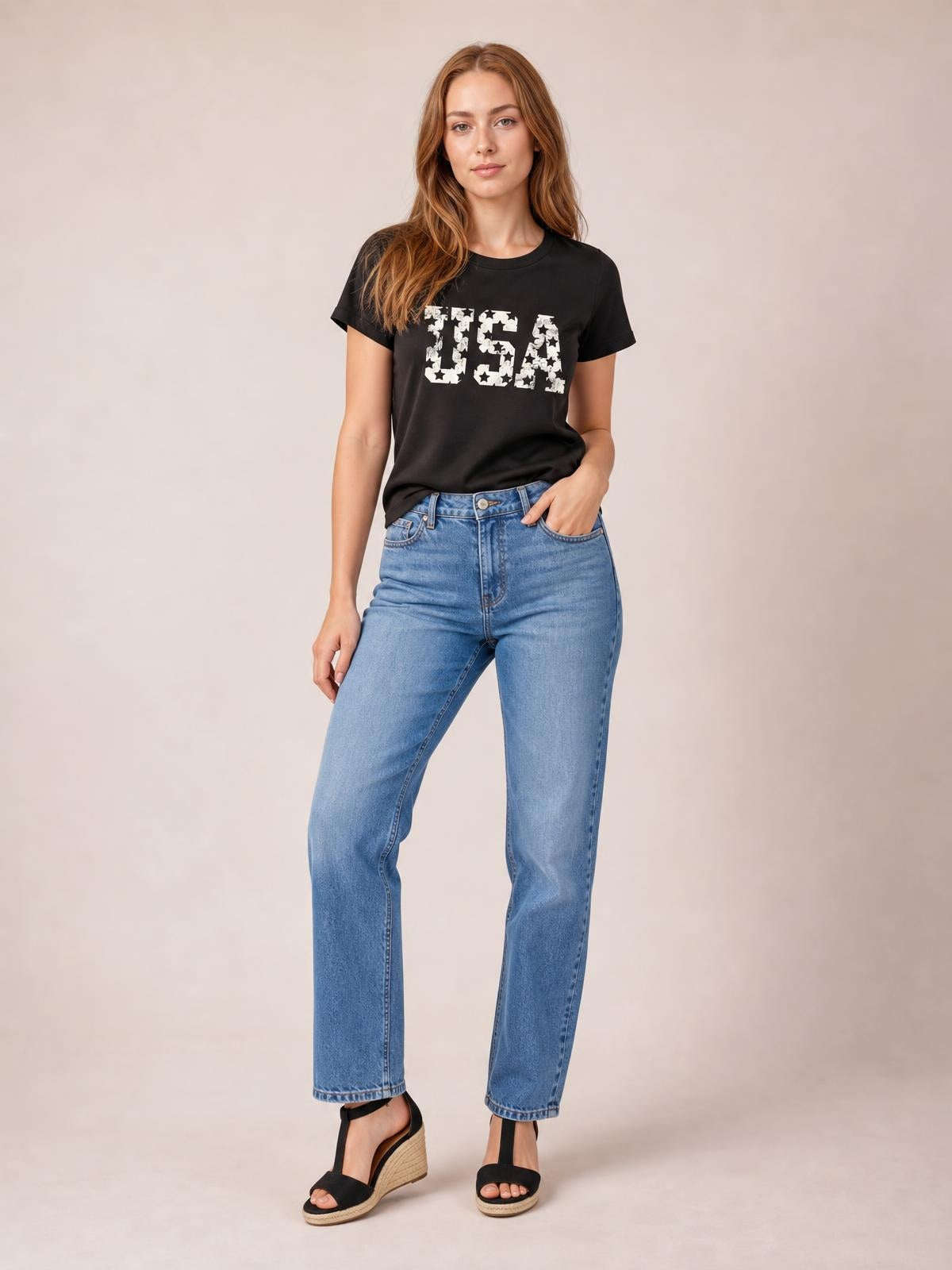 Model poses in a black USA round neck short sleeve T-shirt with a relaxed straight silhouette and bold white star lettering across the front.