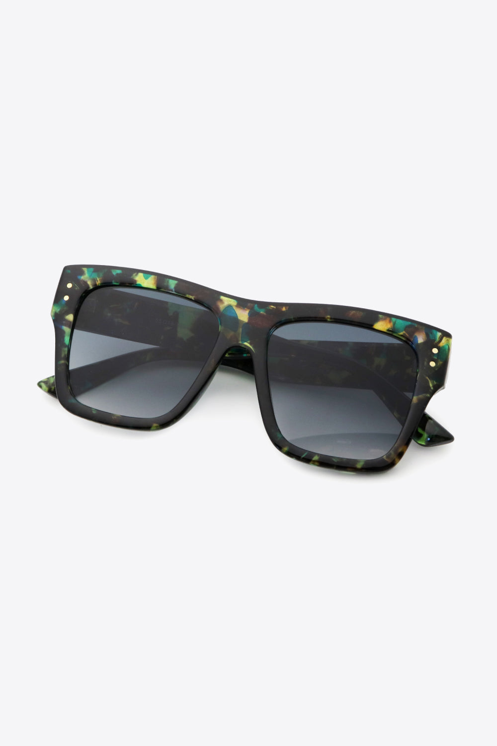 UV400 square sunglasses feature a bold black polycarbonate frame with a multicolor patterned finish, broad dark lenses, and sturdy folded temples.