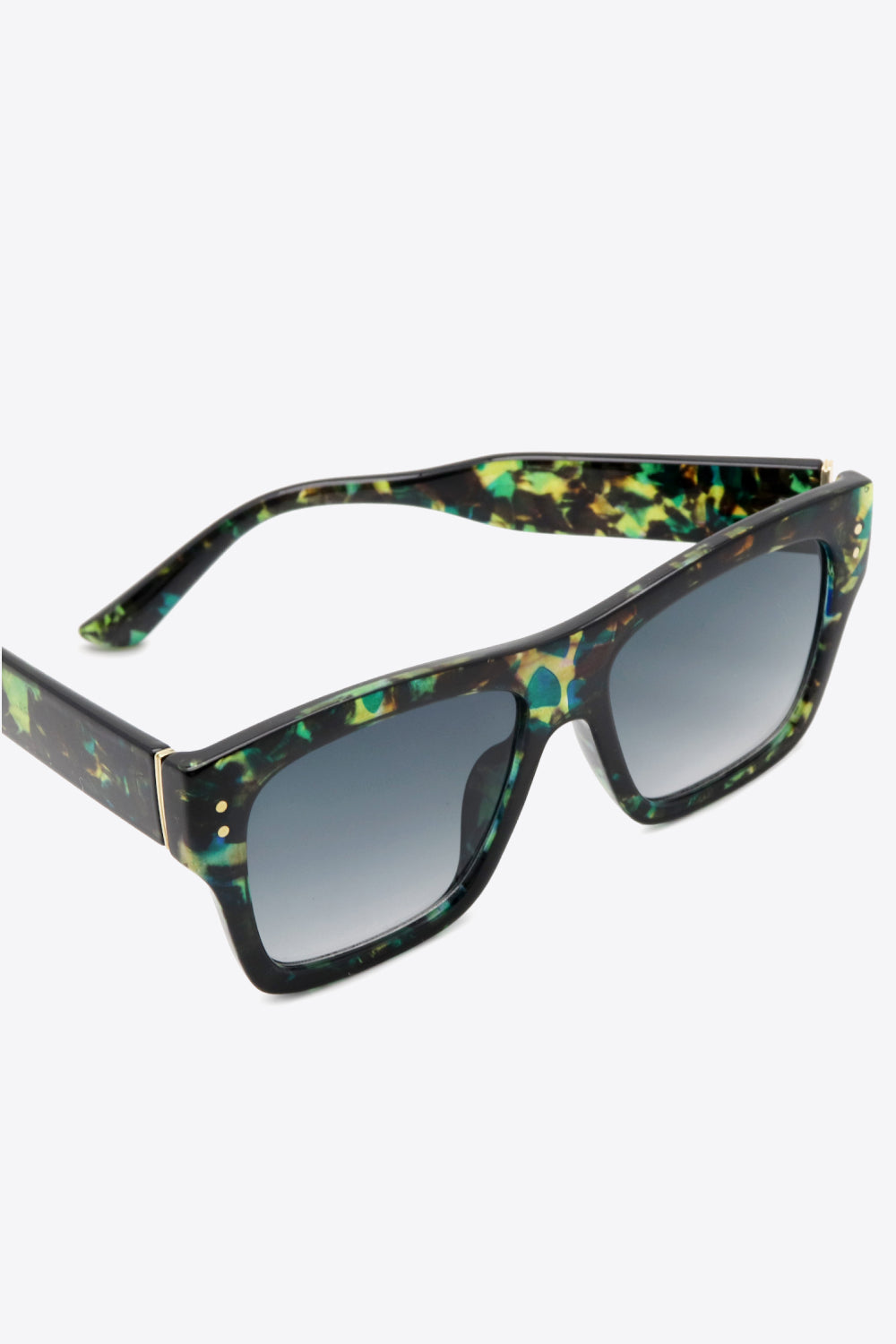 Square UV400 sunglasses feature a bold black polycarbonate frame with a multicolor pattern, broad lenses, dark gradient lenses, and slim gold temple accents.