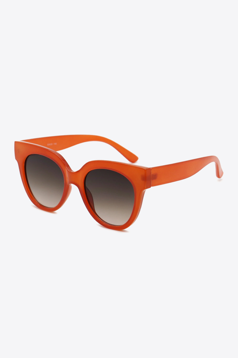 Deep red round sunglasses feature bold polycarbonate frames, softly curved temples, and gradient-toned lenses with a polished retro-inspired silhouette.