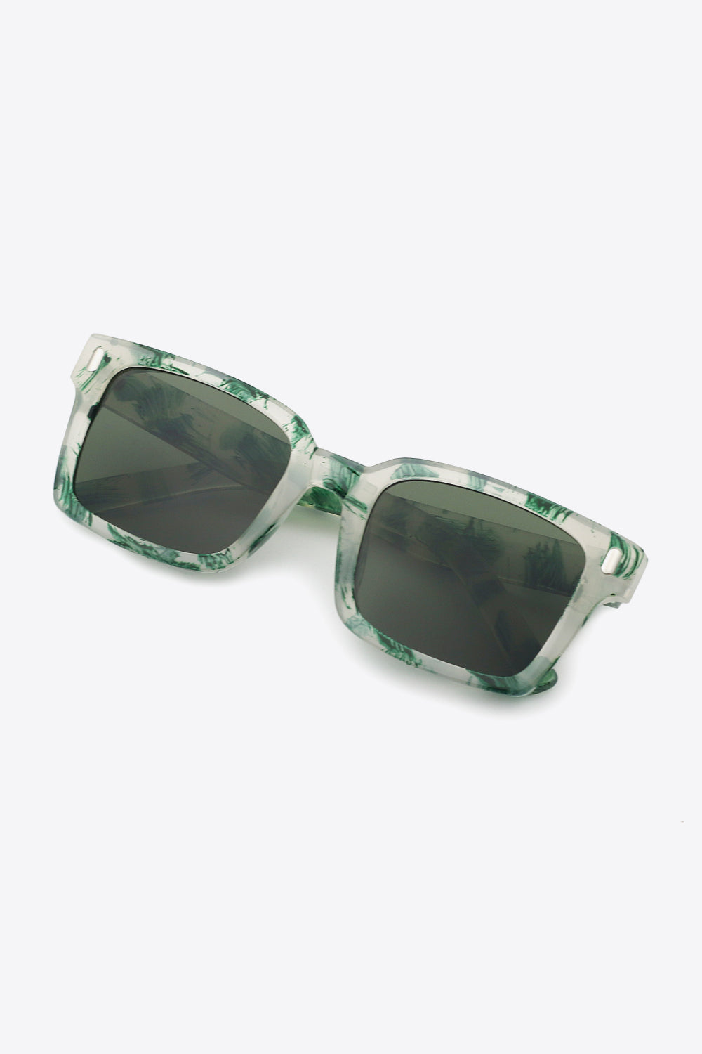 Translucent green marbled polycarbonate UV400 sunglasses feature broad softly rounded-square frames, dark lenses, and defined temples for a bold silhouette.