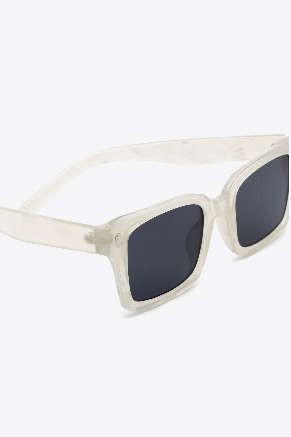 Translucent polycarbonate square sunglasses feature broad softly rounded frames, dark lenses, and streamlined temples for a modern statement silhouette.