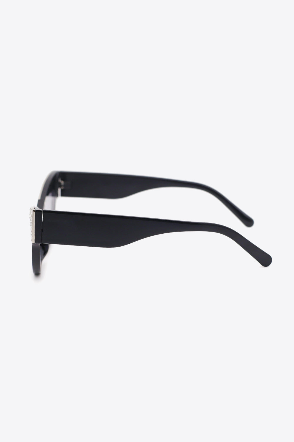Black UV400 rhinestone-trim cat-eye sunglasses shown in side profile with broad black polycarbonate temples and a polished metal-plastic frame.