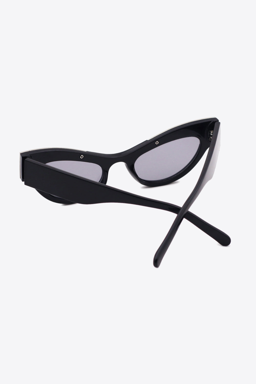 Black UV400 cat-eye sunglasses feature a sharply lifted silhouette, dark tinted lenses, a bold polished frame, and crossed polycarbonate temples.