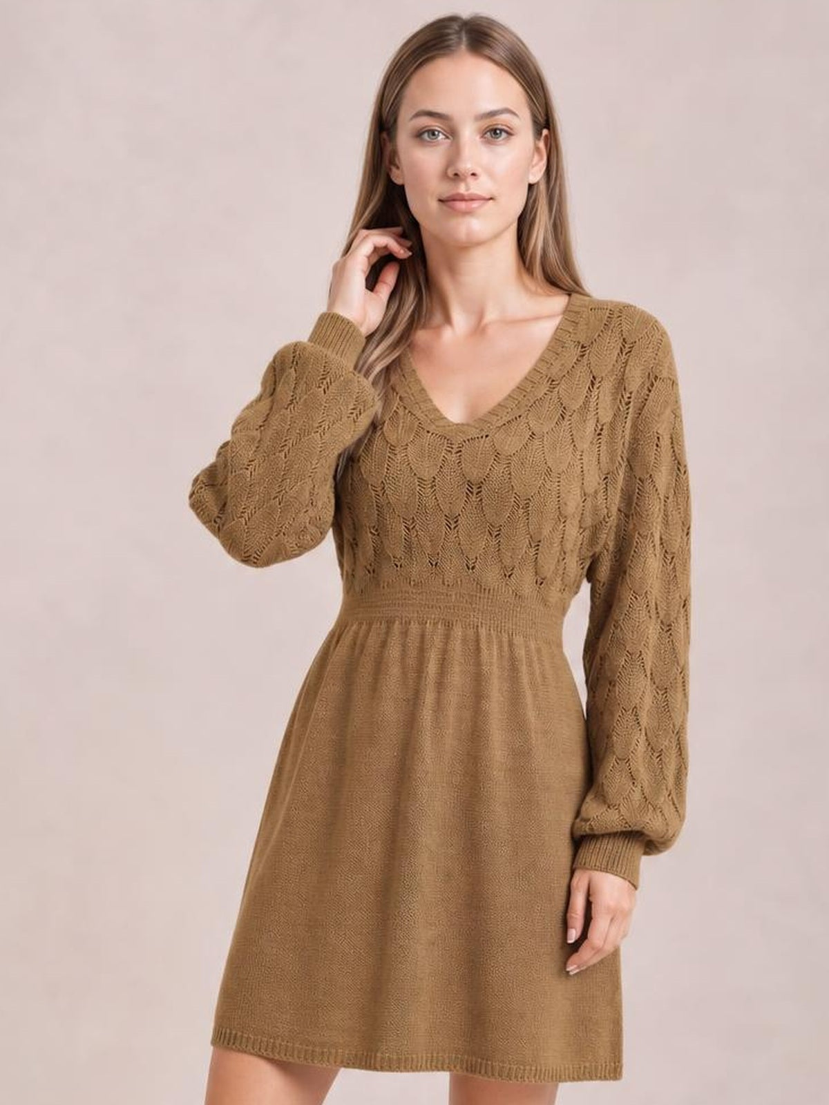 Model poses in a brown V-neck long sleeve sweater dress with openwork knit detailing, ribbed cuffs and waist, and a gently flared above-knee silhouette.