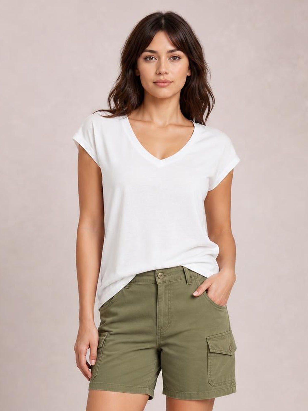 Model wearing a white V-neck short sleeve T-shirt with a relaxed silhouette and clean basic construction, paired with olive cargo shorts.