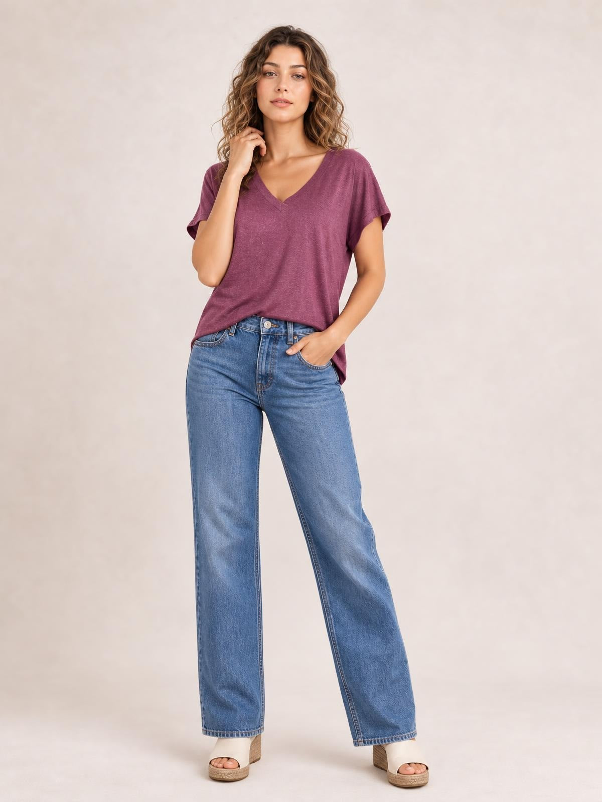 Model wears a plum V-neck short sleeve T-shirt with a relaxed straight silhouette, slightly rolled sleeves, and a gently curved hem.