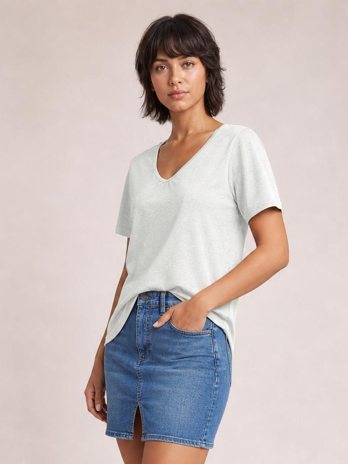 Model wearing a light gray V-neck short sleeve T-shirt with a relaxed straight silhouette, clean neckline, and slightly stretchy opaque construction.