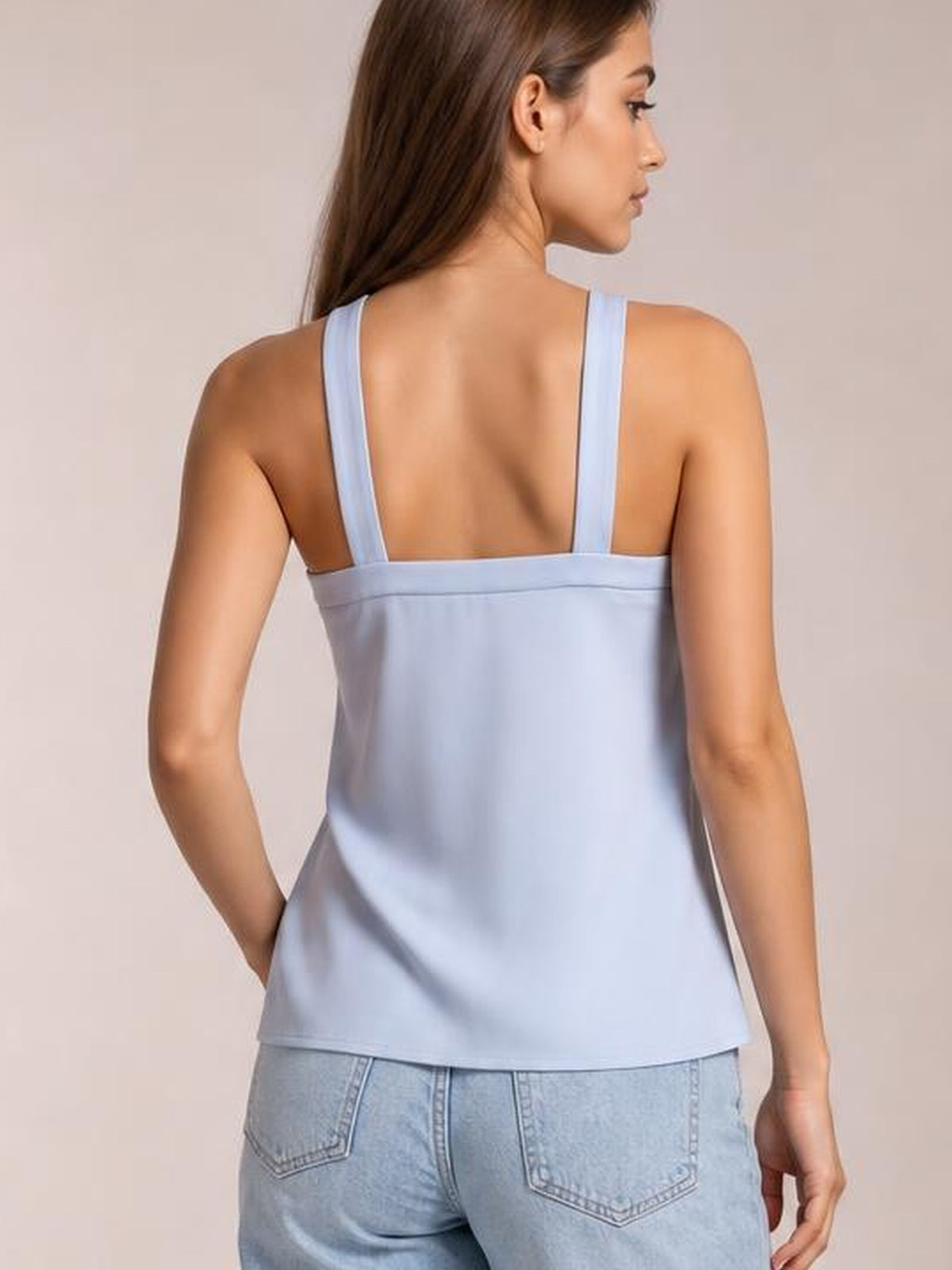 Model shown from the back wears a light blue wide-strap cami with a straight, relaxed silhouette and broad upper-back band.