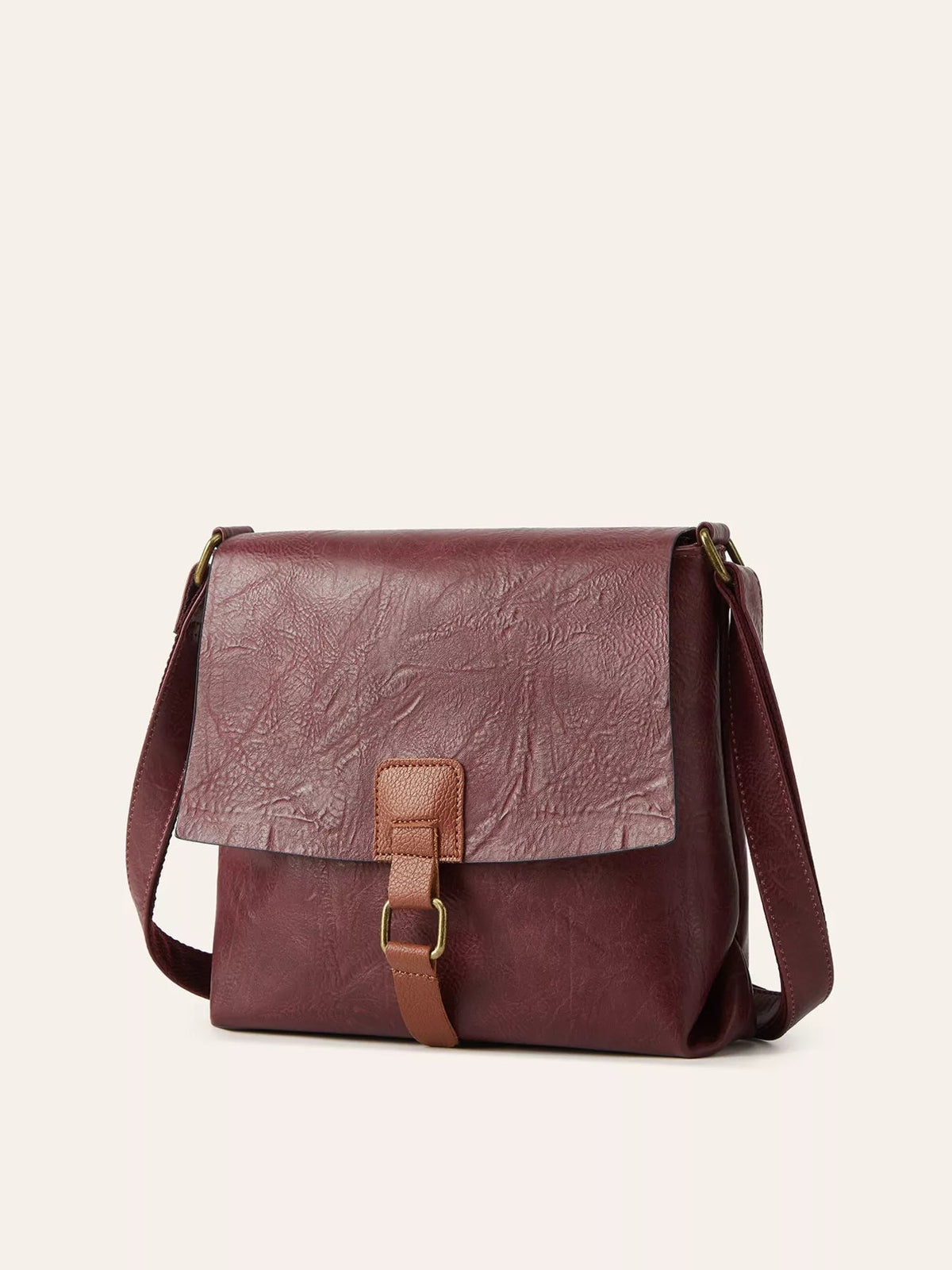 Vintage burgundy PU leather crossbody bag with a structured silhouette, textured flap, brown buckle strap closure, and long shoulder strap.