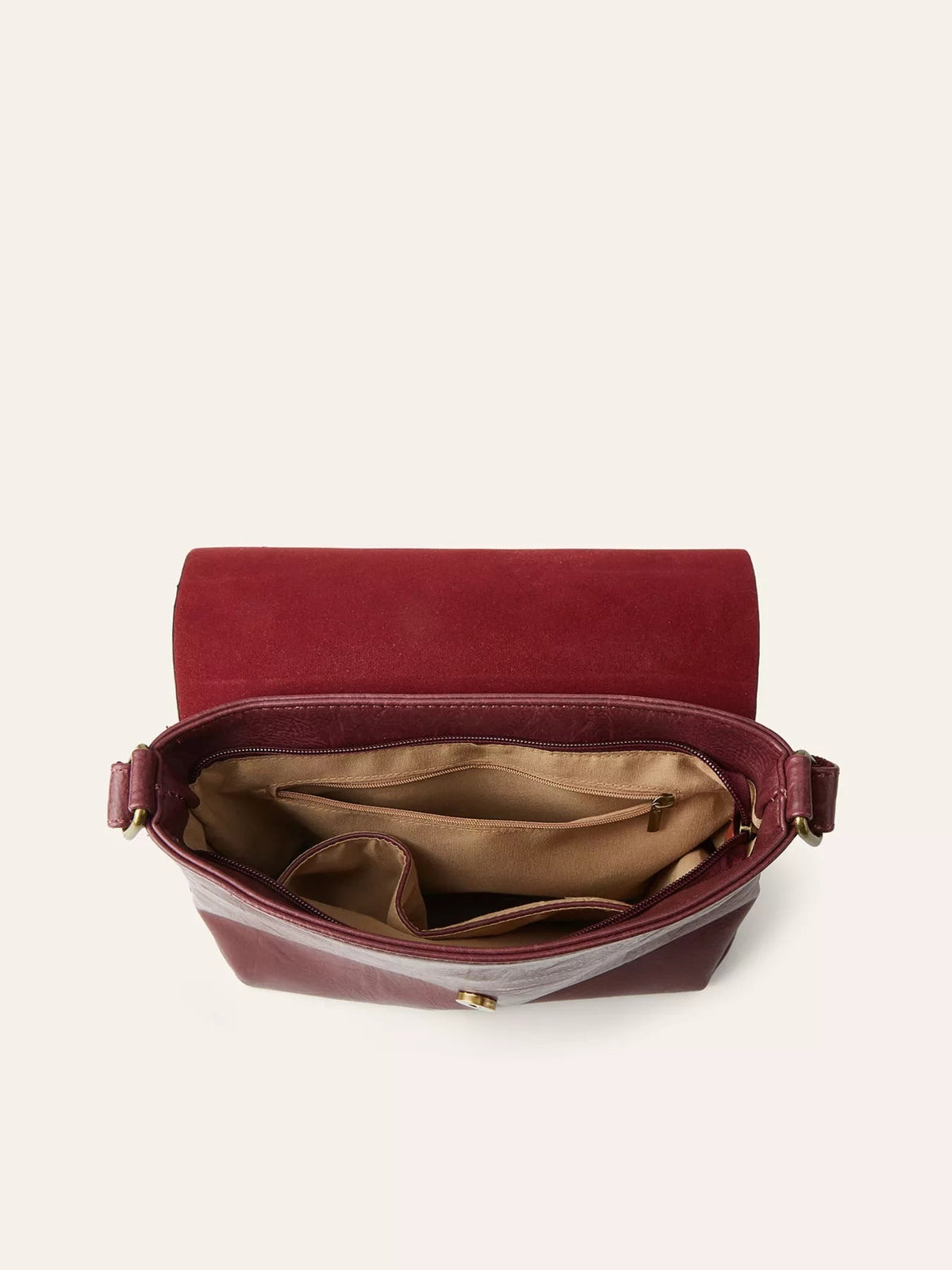 Open medium burgundy PU leather crossbody bag with a flap closure, gold-tone hardware, zip pocket, and spacious tan-lined interior compartments.