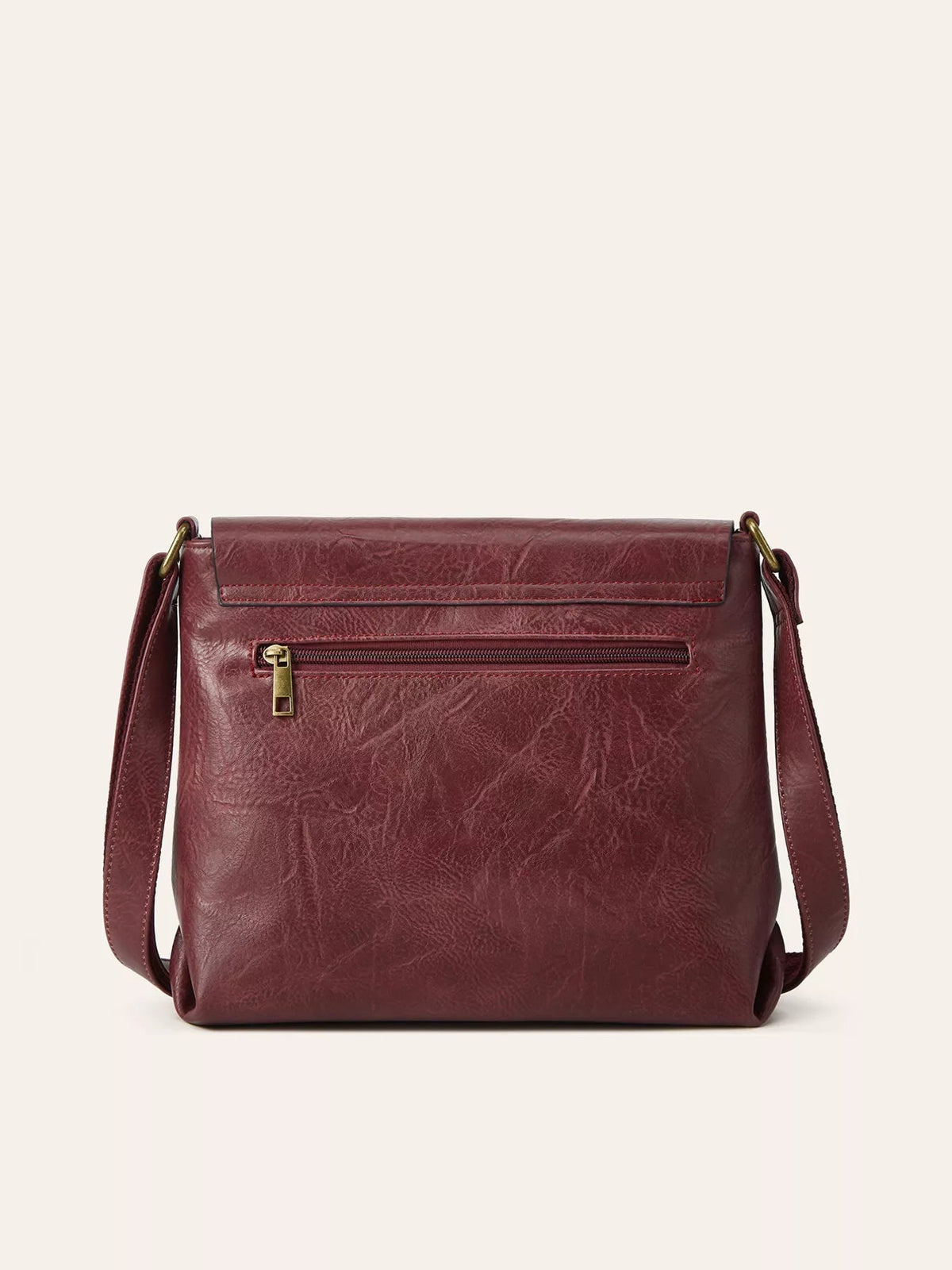 Medium burgundy PU leather crossbody bag with a structured silhouette, wide flap, adjustable shoulder strap, gold-tone hardware, and front zip pocket.