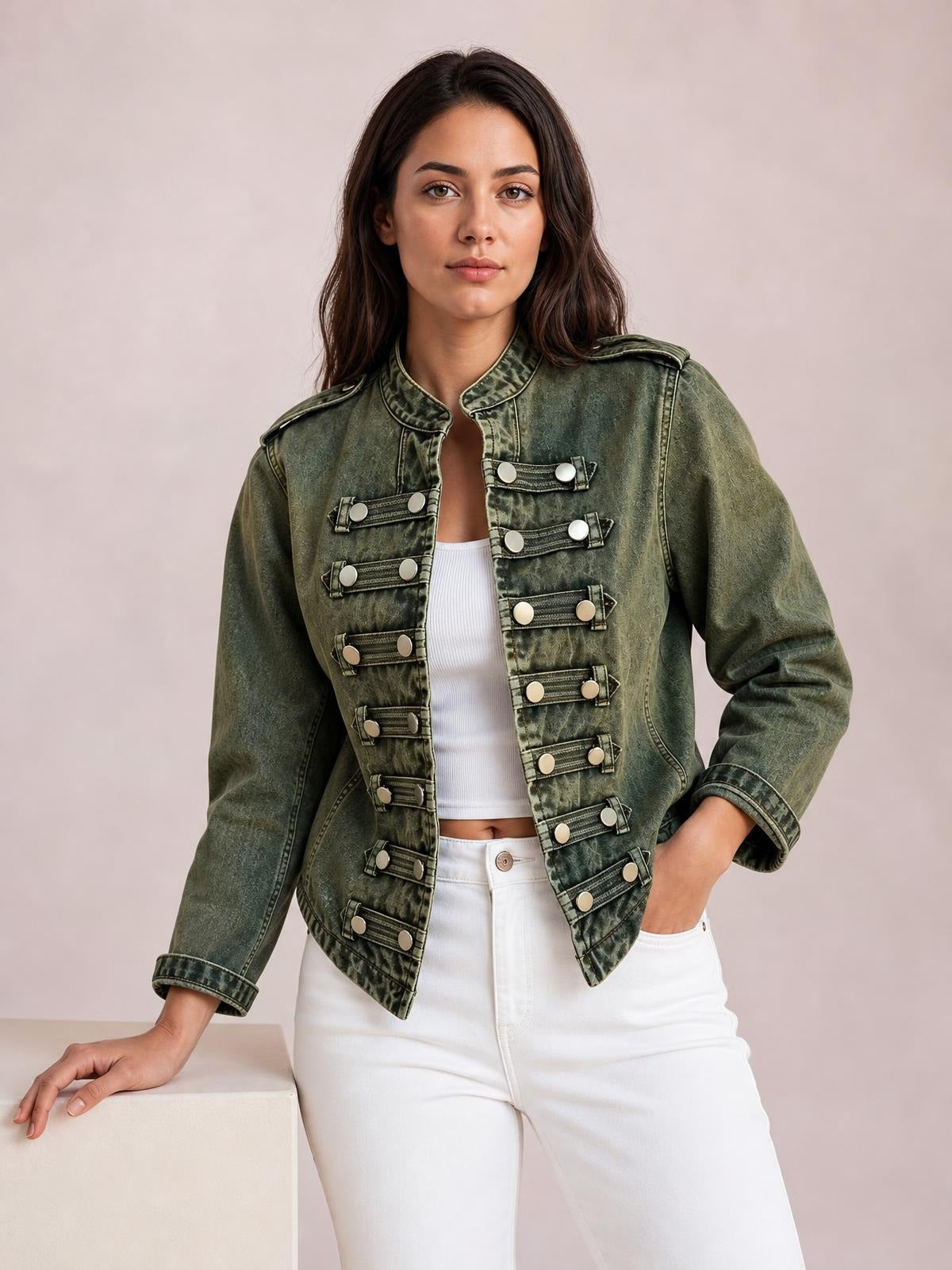 A model poses in a vintage washed olive denim jacket with an open front, stand collar, long sleeves, and rows of decorative buttoned tabs.