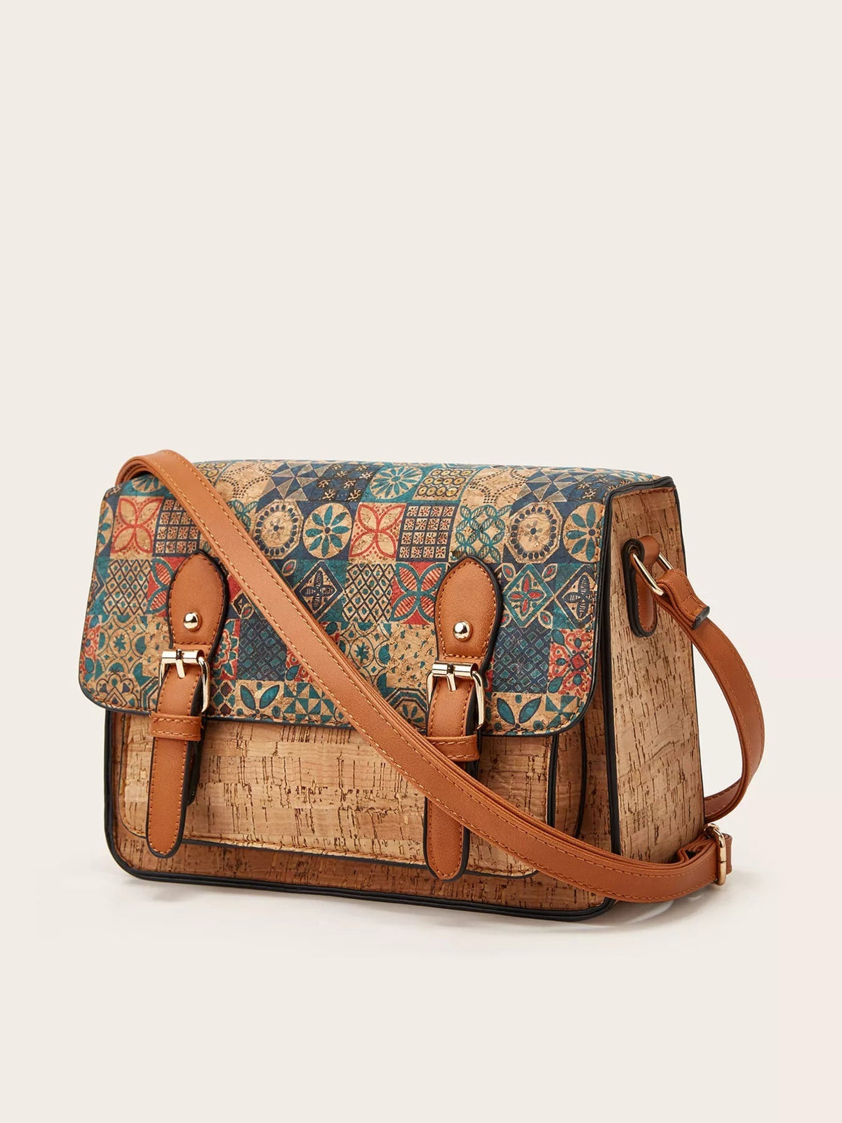 Medium PU leather crossbody bag with a vintage multicolor geometric pattern, structured rectangular silhouette, flap closure, buckle straps, and adjustable tan strap.