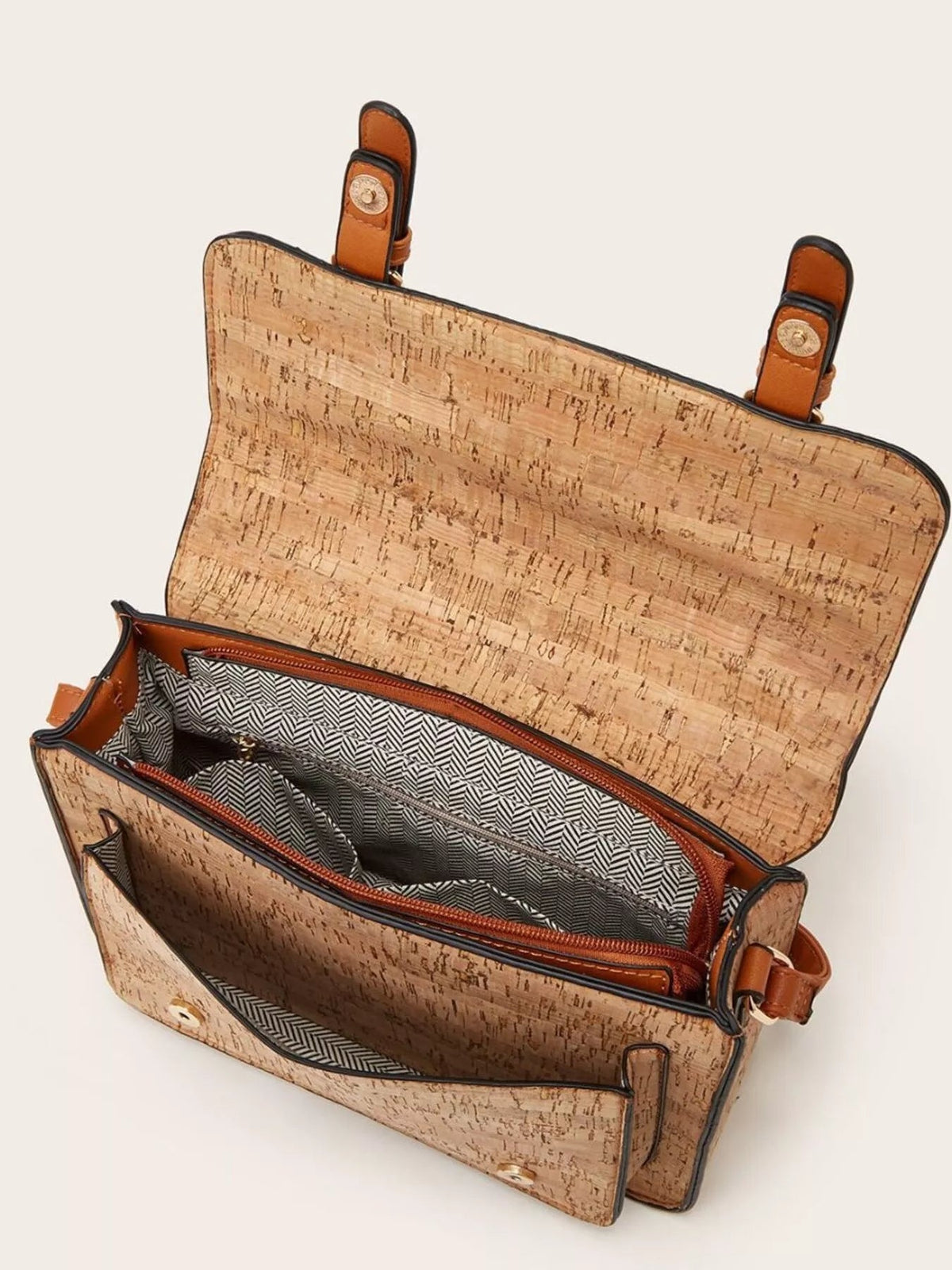 Vintage-patterned tan PU leather crossbody bag shown open, featuring a structured silhouette, brown strap attachments, zip compartments, and geometric fabric lining.