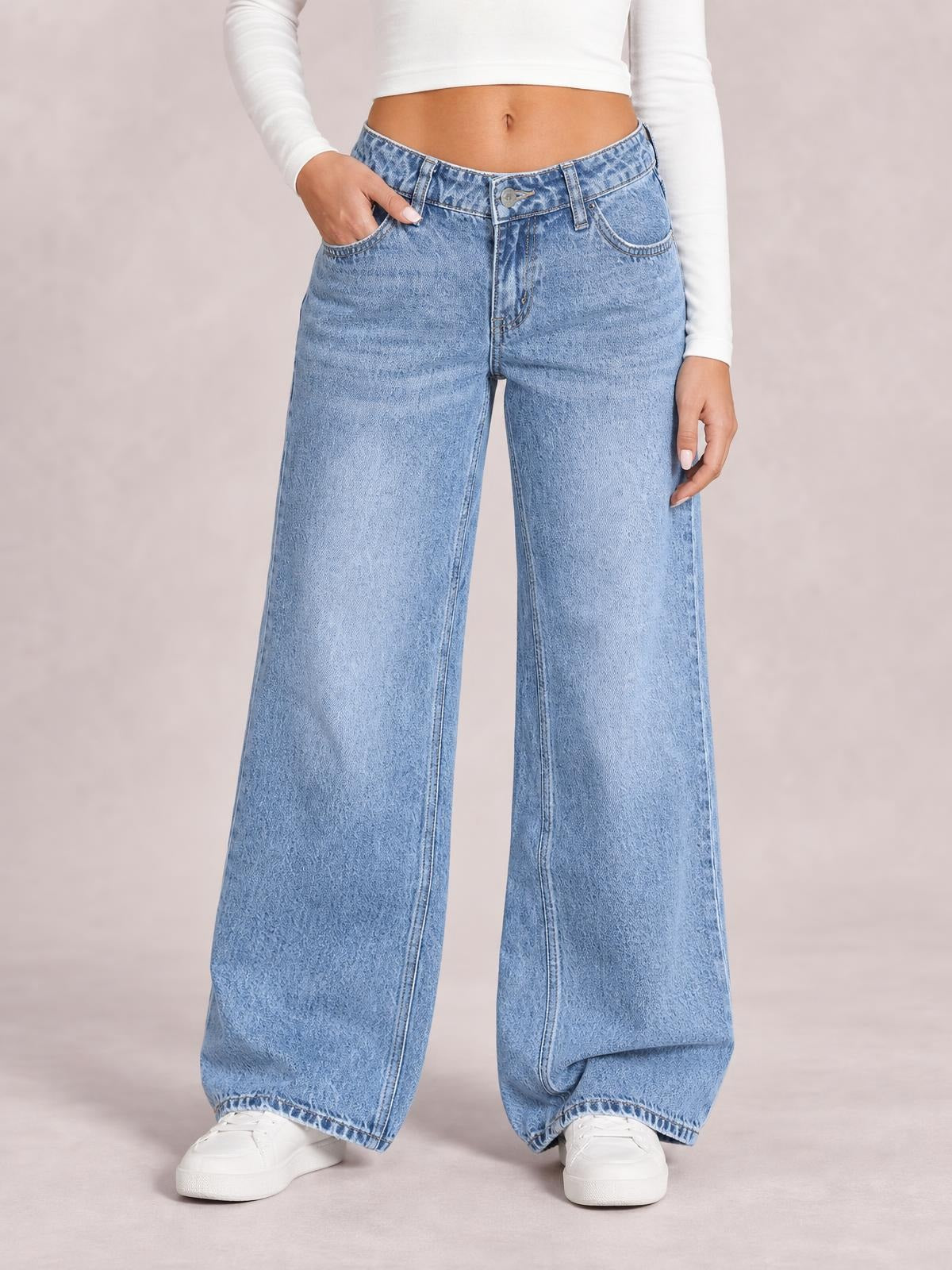 Model wearing light blue washed wide leg jeans with a high-rise waistband, belt loops, front pockets, button fly, and full-length relaxed legs.