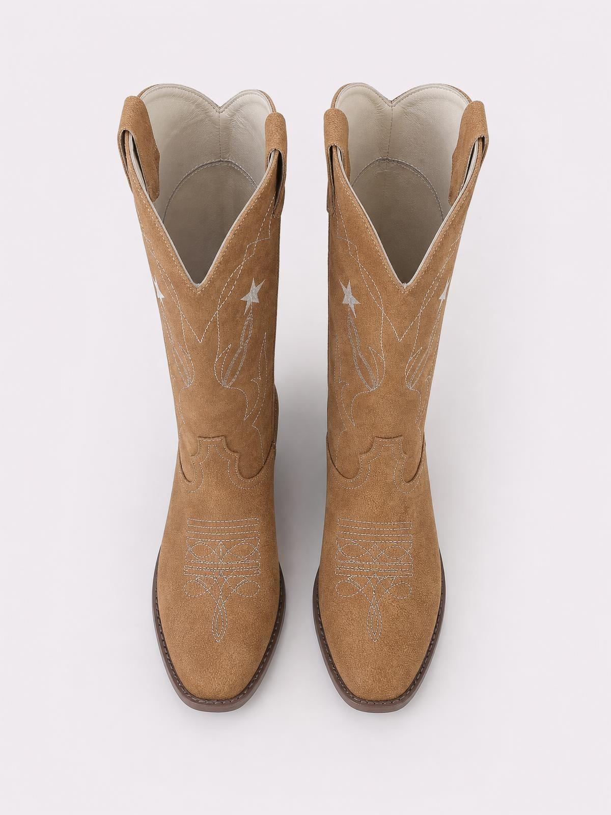 Tan PU leather Western Star cowboy boots feature pointed toes, star embroidery, decorative western stitching, pull tabs, and low stacked heels.