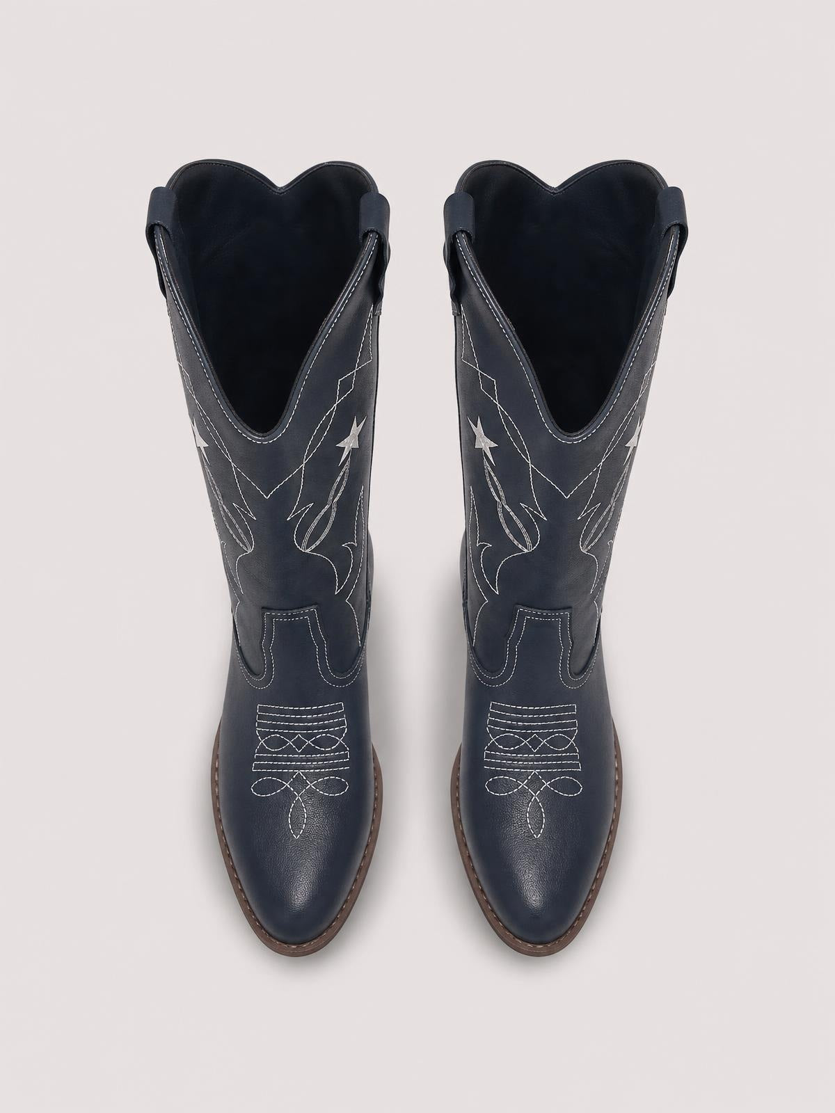 Pair of dark navy Western Star cowboy boots with pointed toes, V-cut shafts, white embroidered stars and decorative stitching, and low heels.