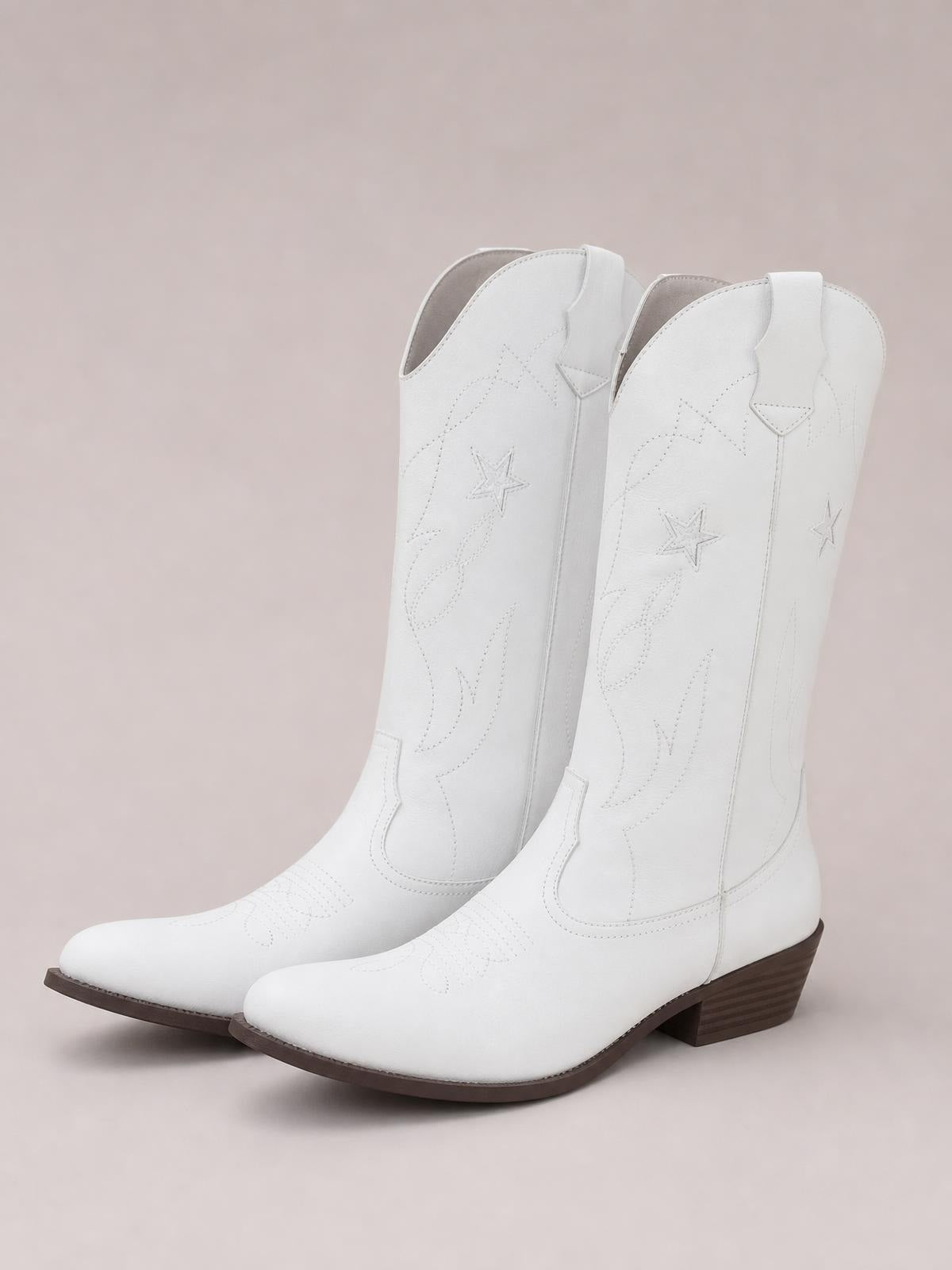 White Western Star cowboy boots feature pointed toes, star embroidery, tall pull-on shafts, brown rubber soles, and low stacked heels.