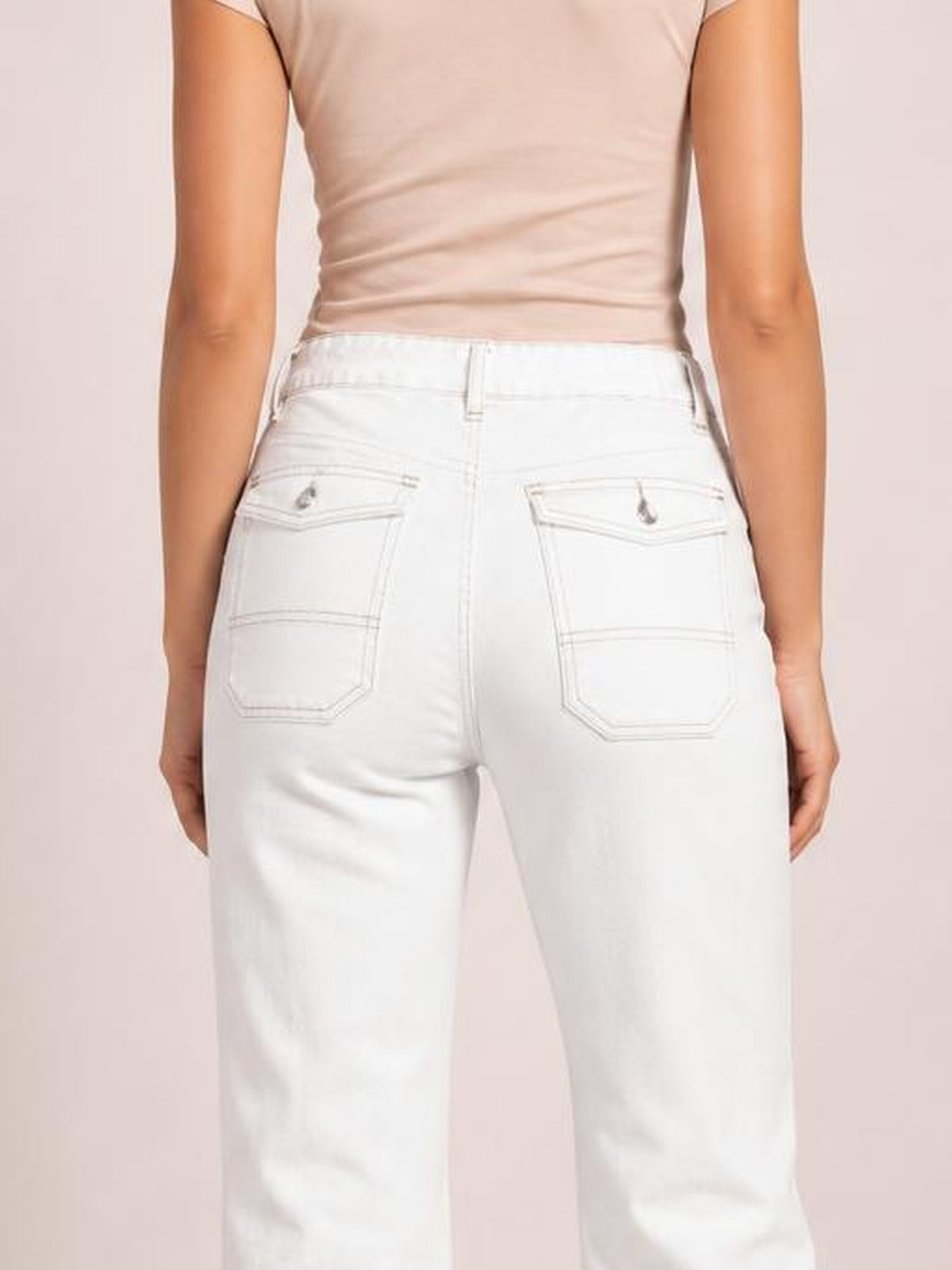 Model viewed from behind wearing white wide-leg jeans with contrast stitching, belt loops, and flap back pockets.
