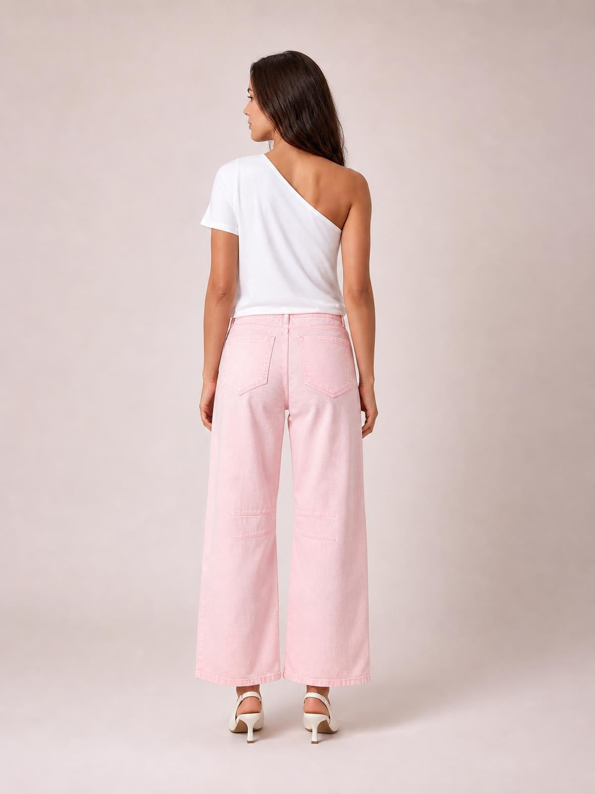 Model shown from the back in pale pink wide-leg jeans with a relaxed silhouette, two patch pockets, and stitched knee panels.