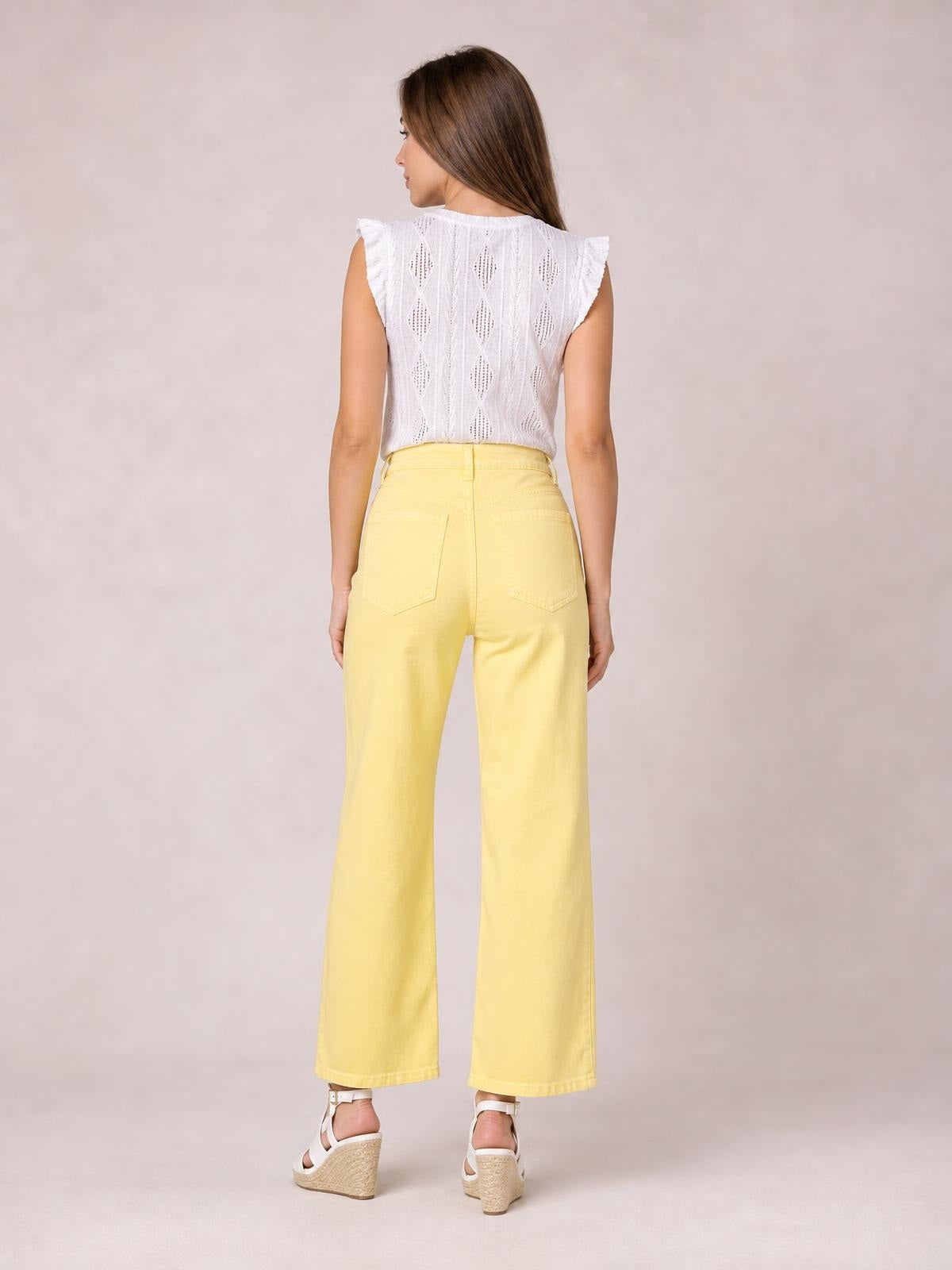 Model shown from behind wears pale yellow wide-leg drawstring jeans with a high waist, belt loops, back pockets, and cropped straight hems.
