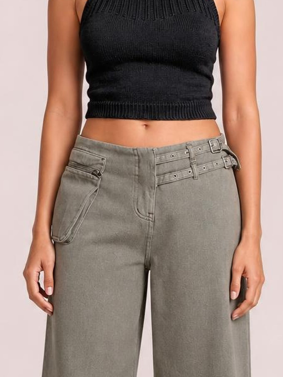 A standing model wears gray wide-leg jeans with visible front pockets, belt loops, and stitched seams in a front-facing pose.