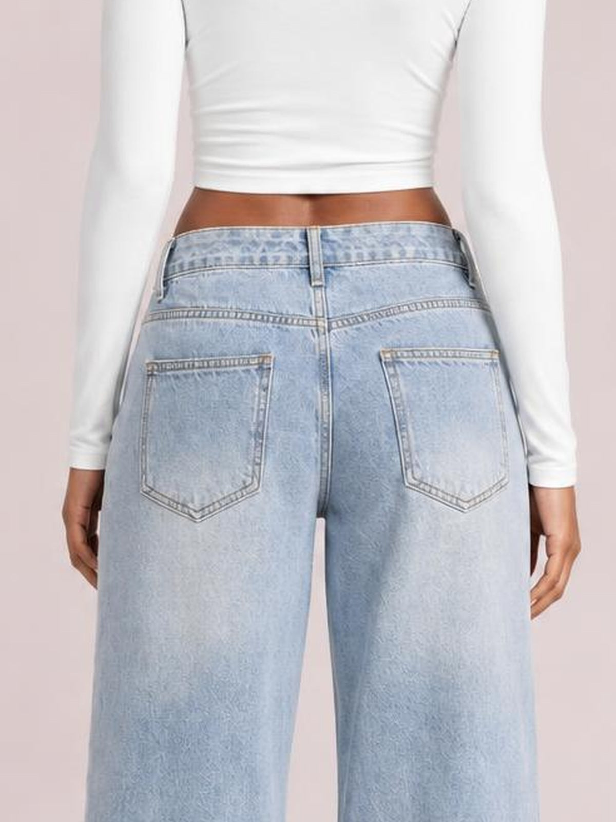 Model shown from the back wearing light blue wide-leg jeans with a buttoned waistband, belt loops, contrast stitching, and two large patch pockets.