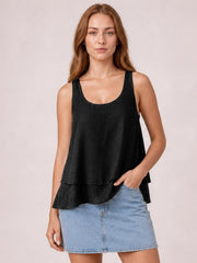 Model wearing a black sheer layered tank with wide straps, a scoop neckline, loose flowy silhouette, and two-tiered hem.