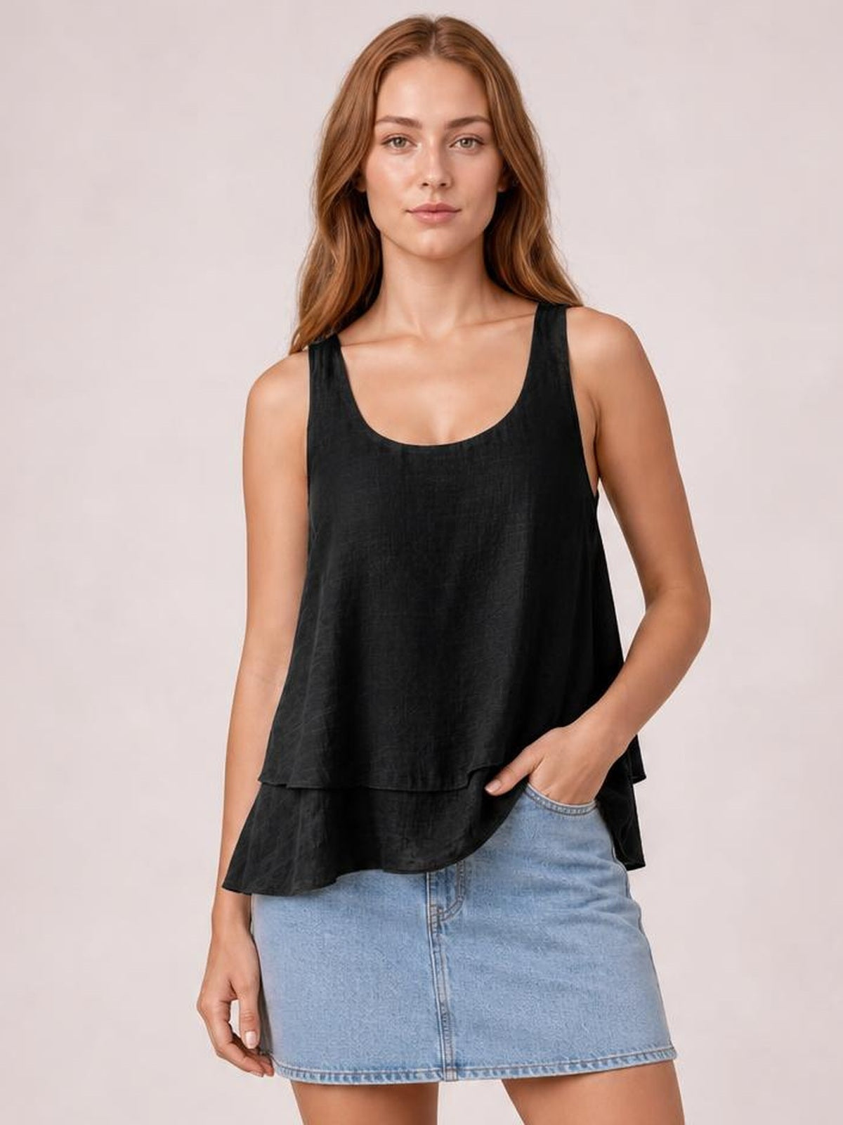 Model wearing a black sheer layered tank with wide straps, a scoop neckline, loose flowy silhouette, and two-tiered hem.