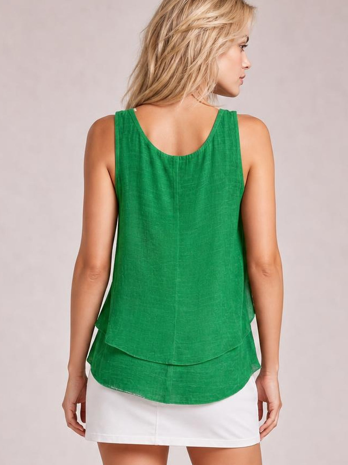 A model shown from behind wears a green sheer layered tank with wide straps, a relaxed silhouette, scoop back, and curved double hem.