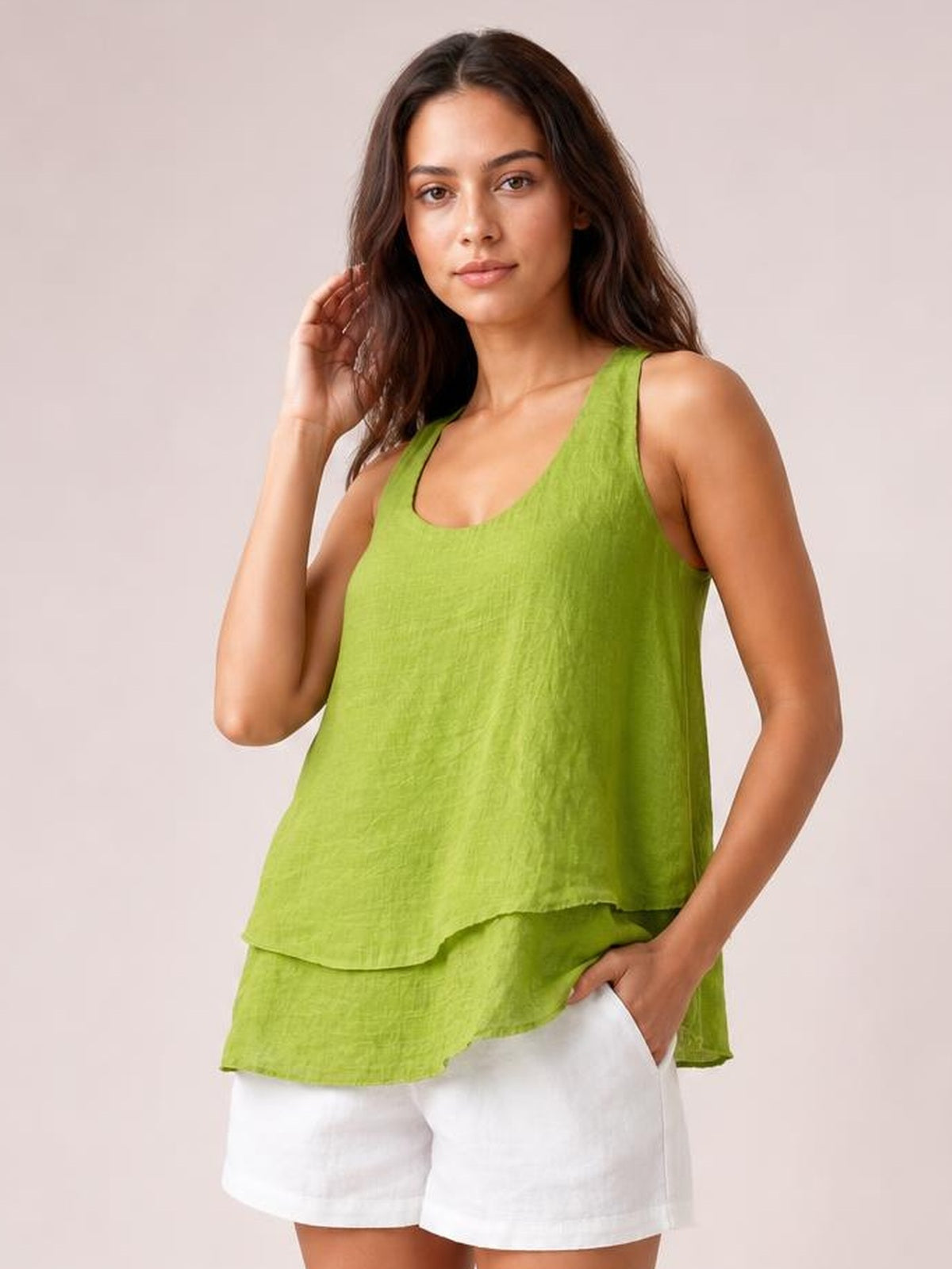 Model poses in a bright lime green wide-strap layered tank with a sheer, relaxed silhouette, curved neckline, and two flowing tiers.