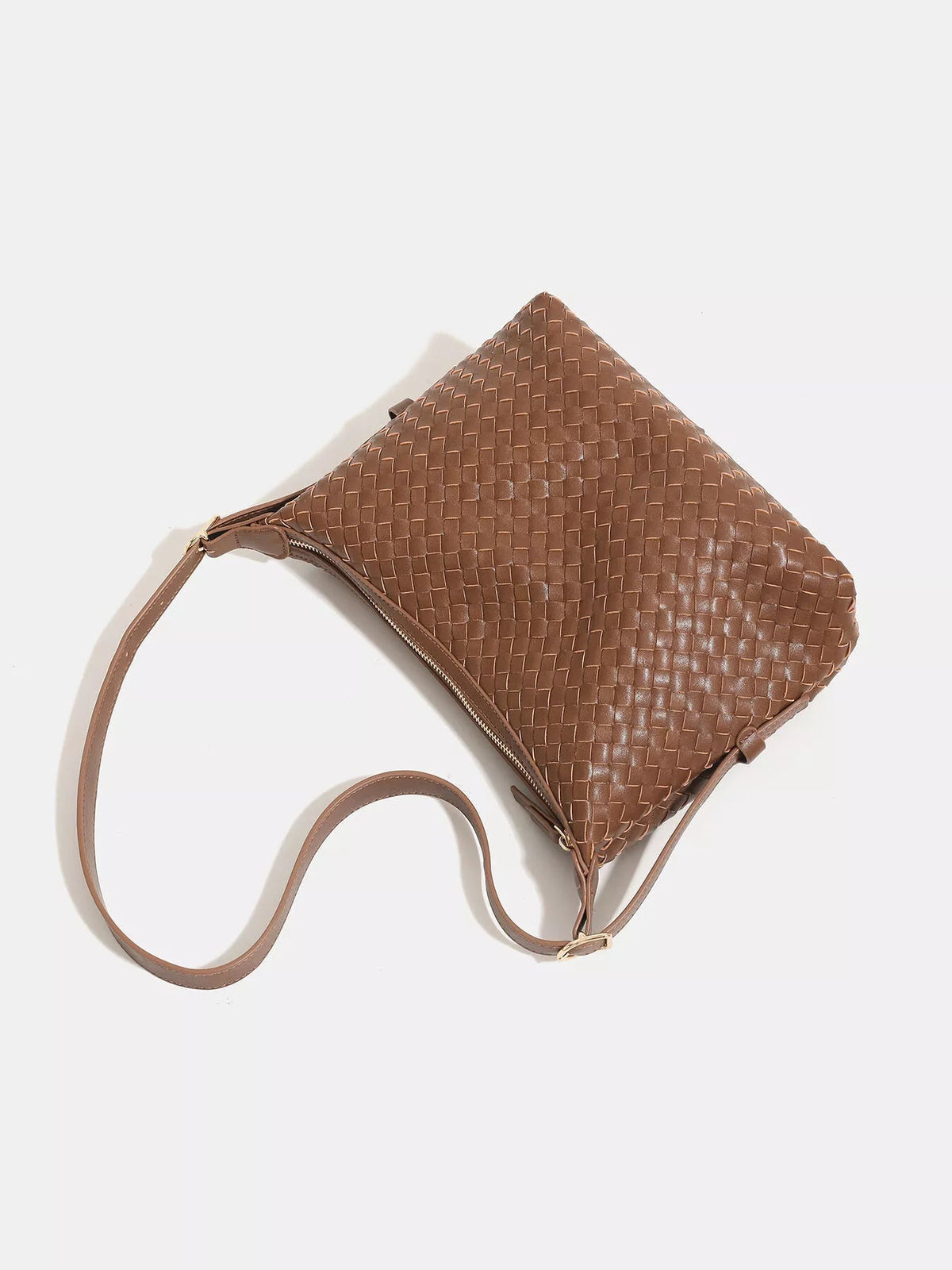 Medium brown woven PU leather shoulder bag with a softly structured silhouette, zippered top, and long adjustable strap.