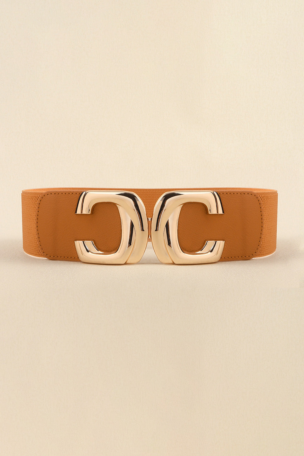 A cognac-brown wide elastic belt features a structured PU band, visible stitching, and a polished zinc alloy double-loop buckle.
