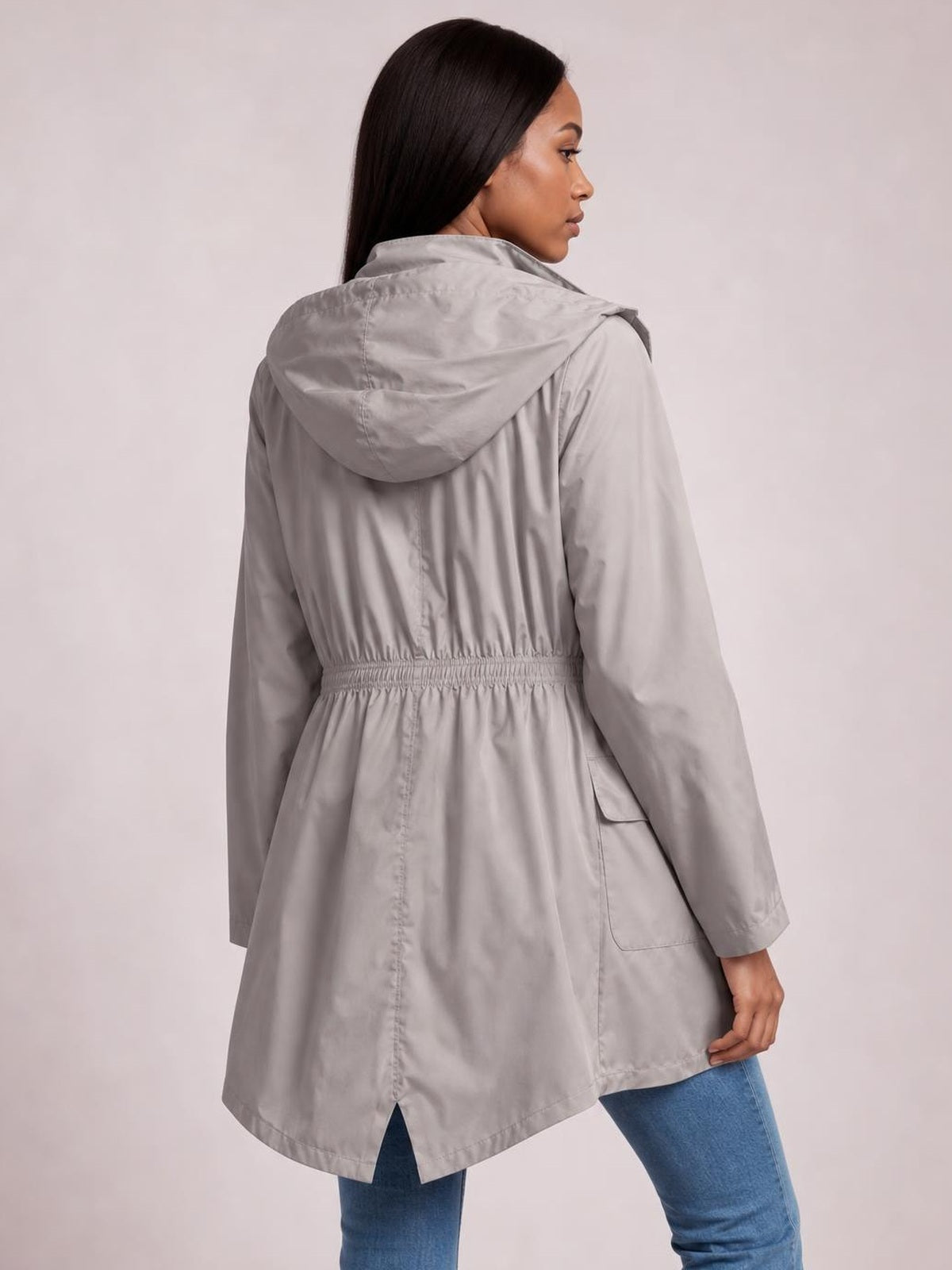 Model shown from the back in a light gray zip-up hooded jacket with long sleeves, a drawstring waist, lined construction, and relaxed regular fit.